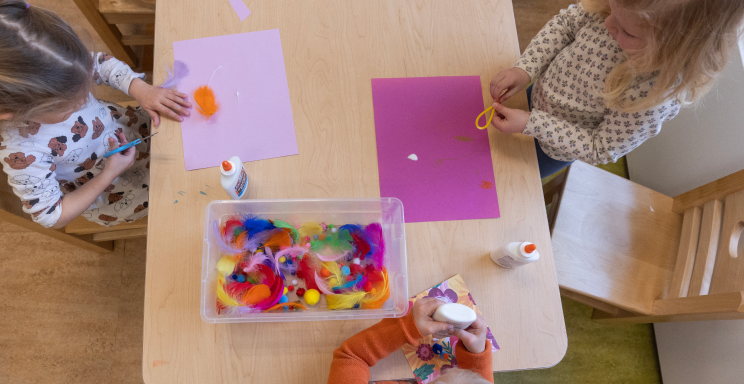 children at a table doing crafts