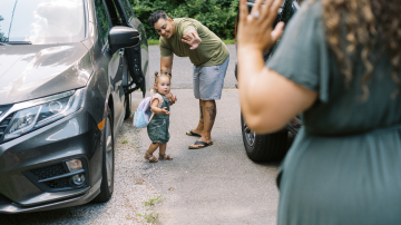 father with child in parking lot